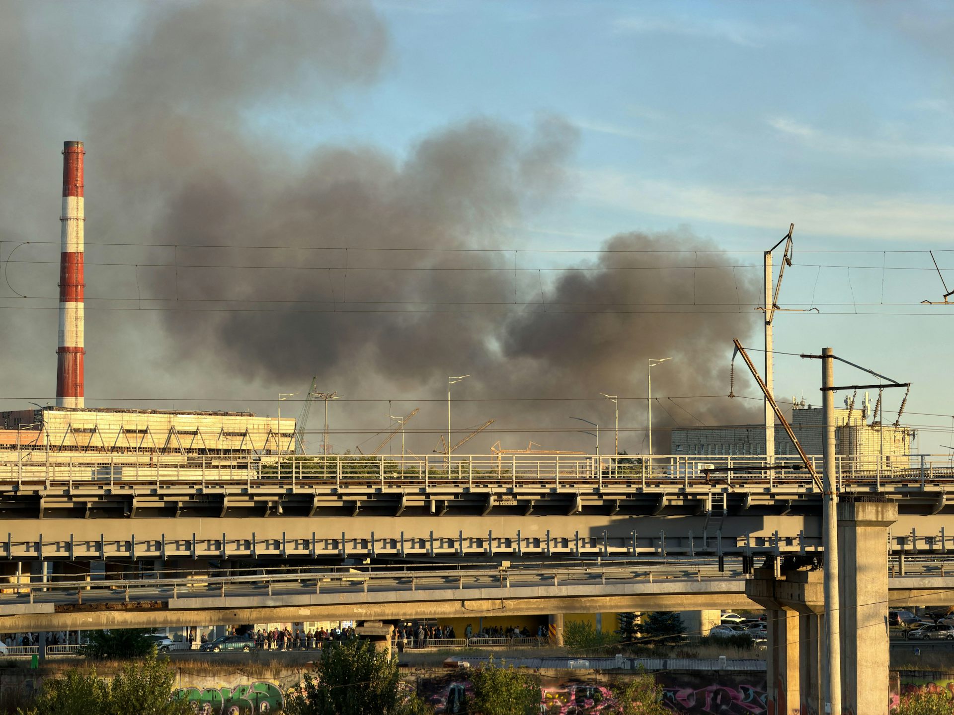 Smoke rises directly behind red-and-white striped chimneys at a Kyiv power plant, September 8 2026.
