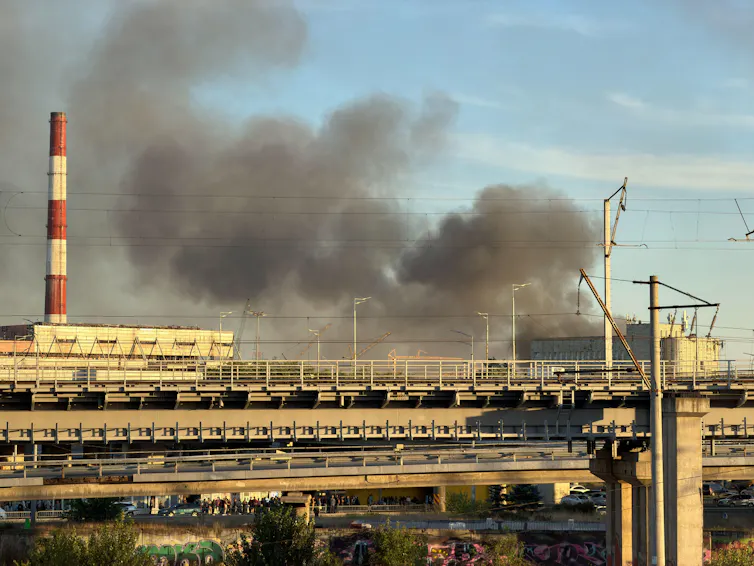 Smoke rises directly behind red-and-white striped chimneys at a Kyiv power plant, September 8 2026.
