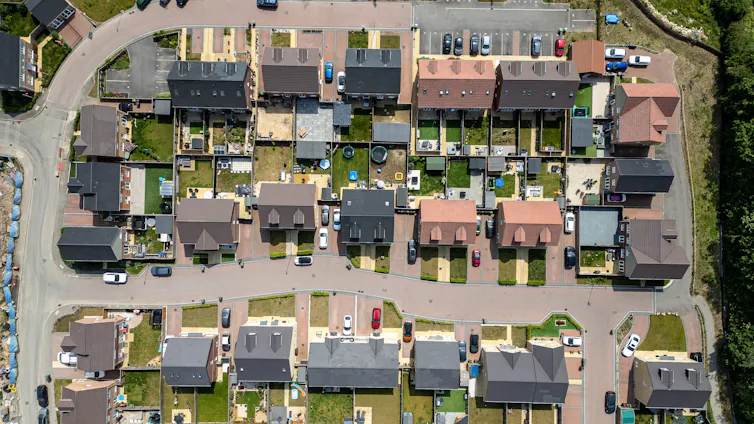 aerial shot of houses and cars parked in driveways