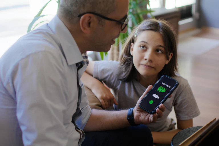A father and his teenage daughter asking an AI Chatbot mobile app questions using a smart phone.