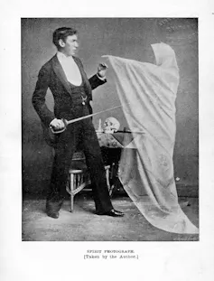 A Victorian man tussling with a ghostly figure in a white sheet.