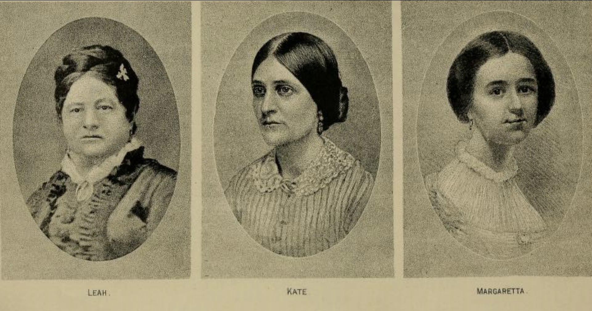Three austere-looking Victorian women dressed in black.