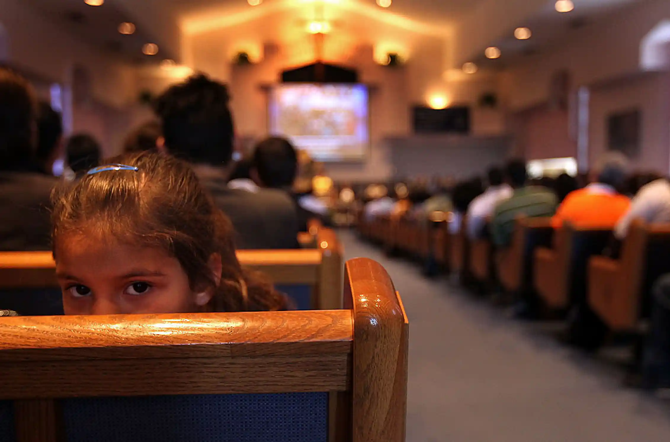A sanctuary full of people, photographed from the back of the room.
