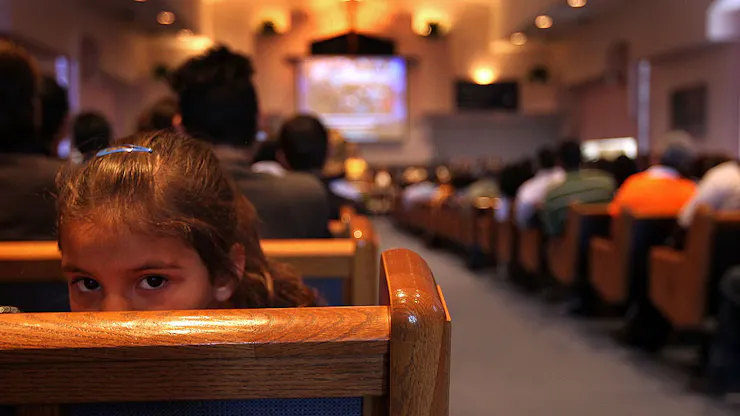 A sanctuary full of people, photographed from the back of the room.