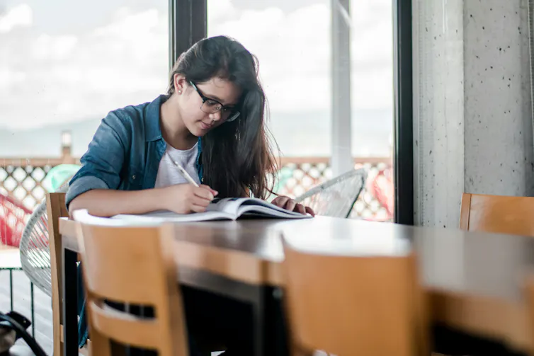 A young woman studying at a table