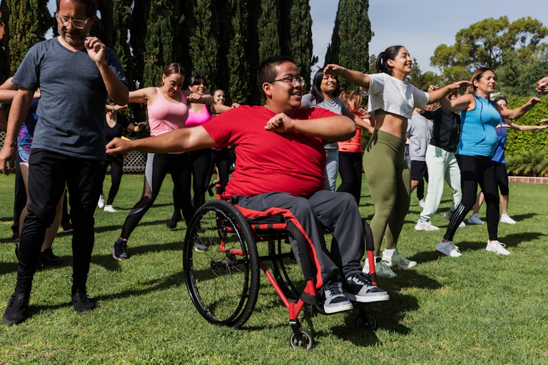 Person in a wheelchair taking part in an outdoor exercise class