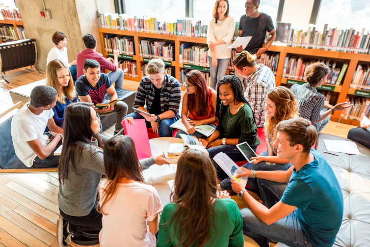 A group of young people studying together in a library