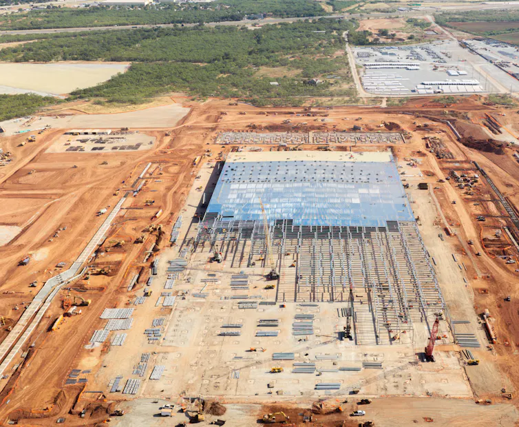 A vast data center under construction transforms the landscape.
