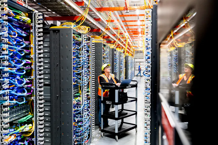 A technician works inside a data center.