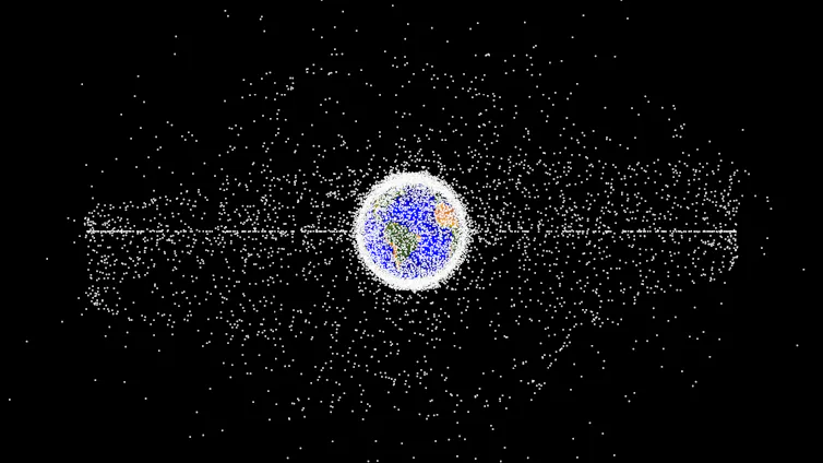 A circle with blue and yellow inside, semi-covered and ringed by white dots outside, also surrounded by many white dots, on a black background.