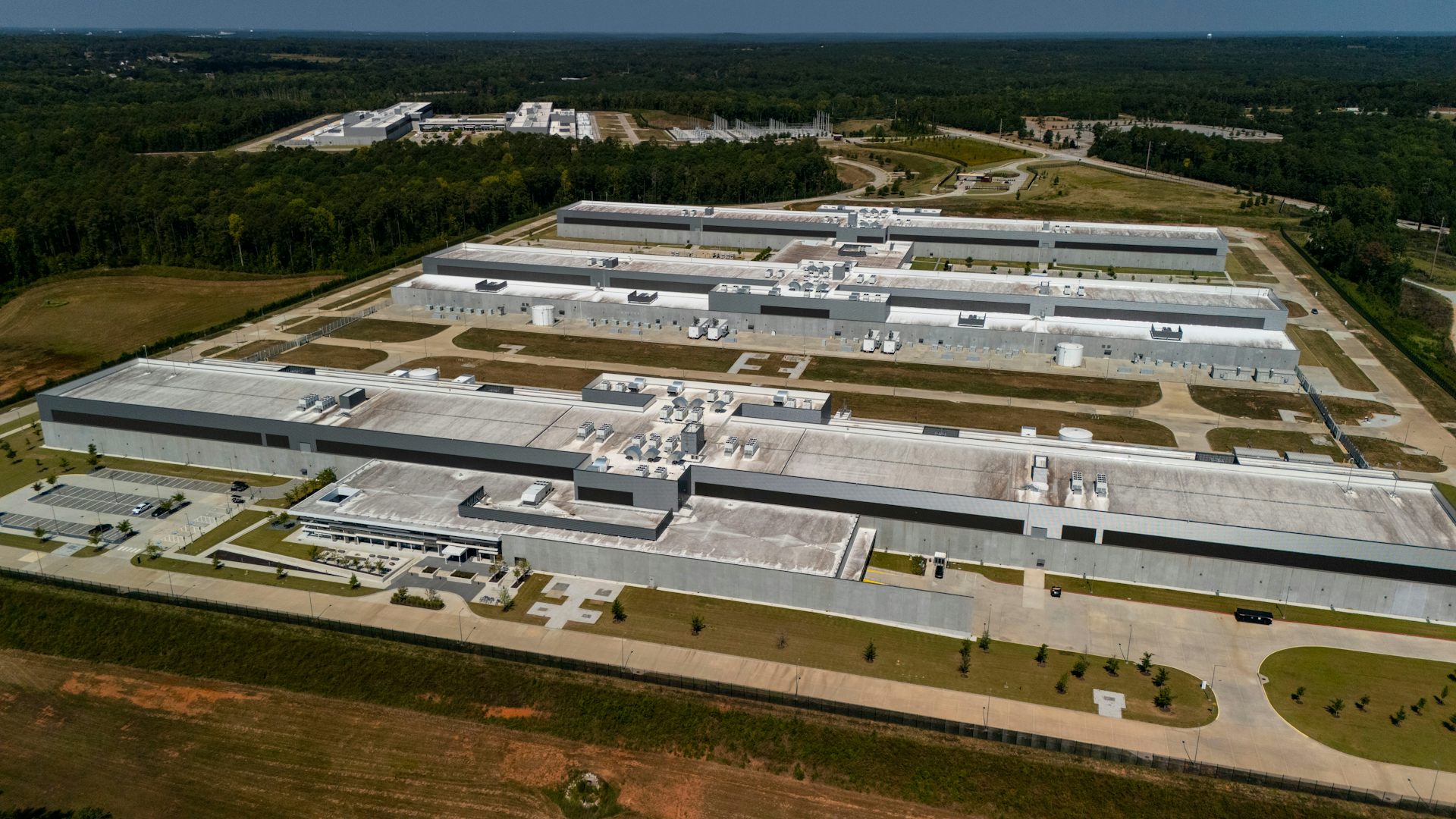 Aerial view of several long, flat buildings