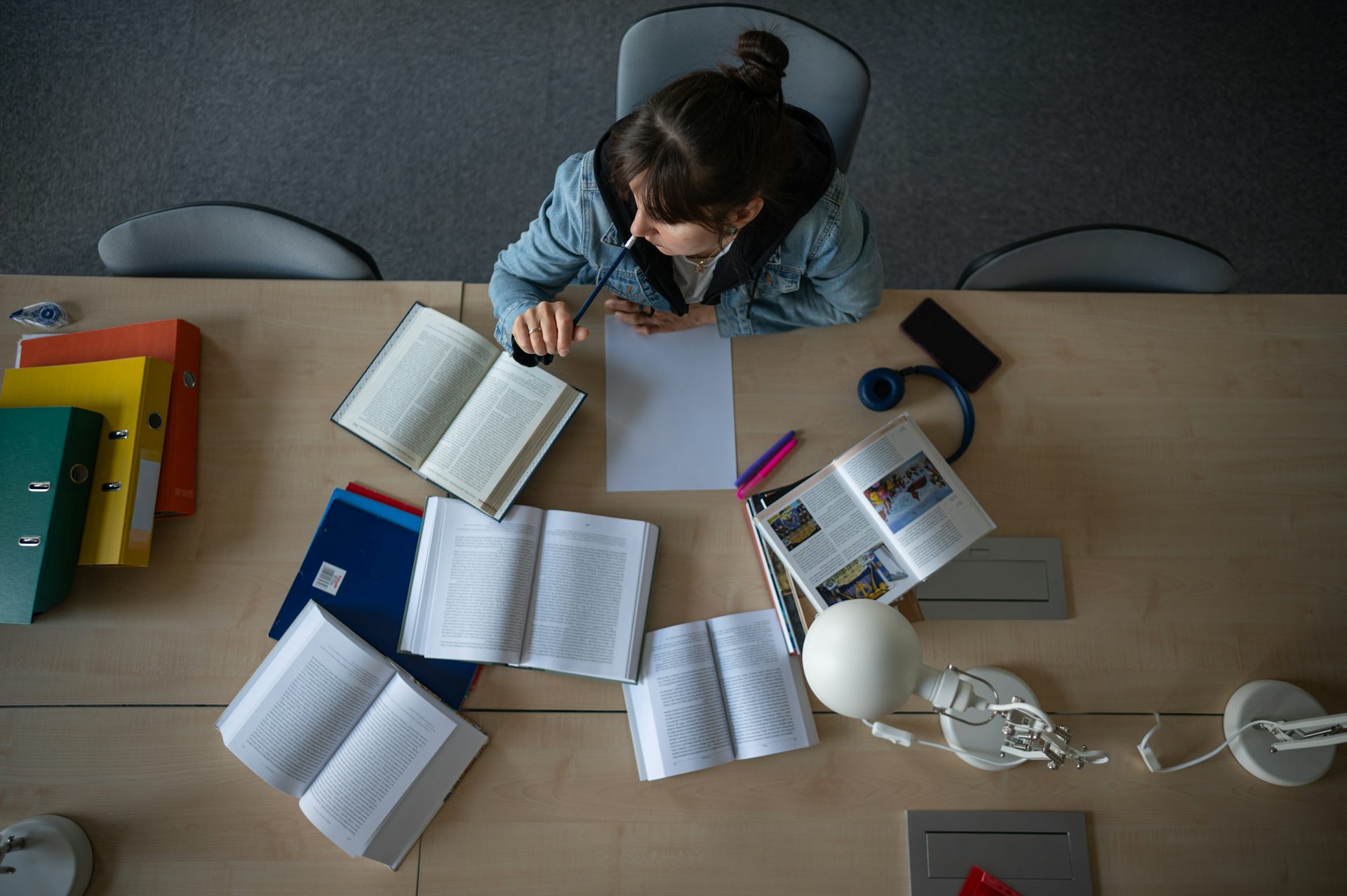 Photo from above of young woman studying