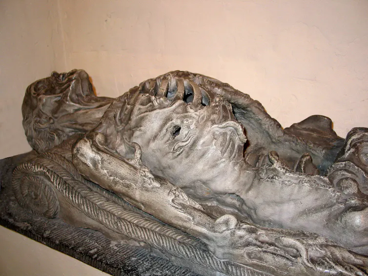 Sculpture of a cadaver partly eaten by worms