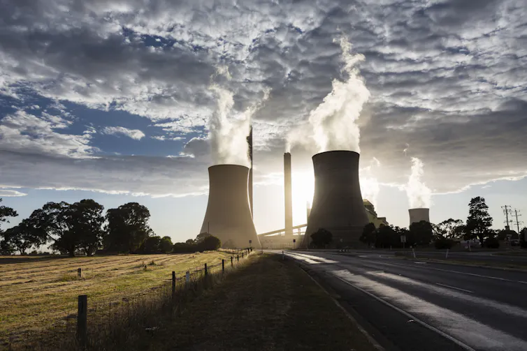 View of smokestacks and cooling towers at a coal power station.