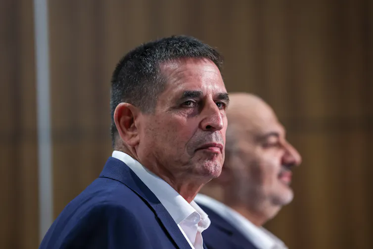 Mansour Abbas and Yoav Segalovitz stand beside one another at a press conference.