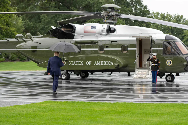 President Donald Trump walking towards a helicopter