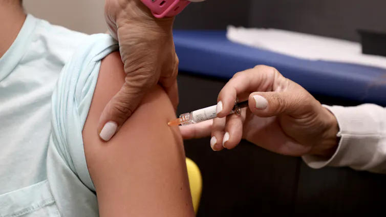 child's arm receiving an injection