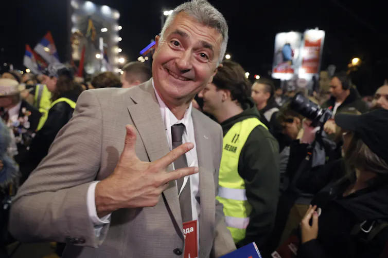 Ilija Srdanović smiles at an election campaign rally in Belgrade.