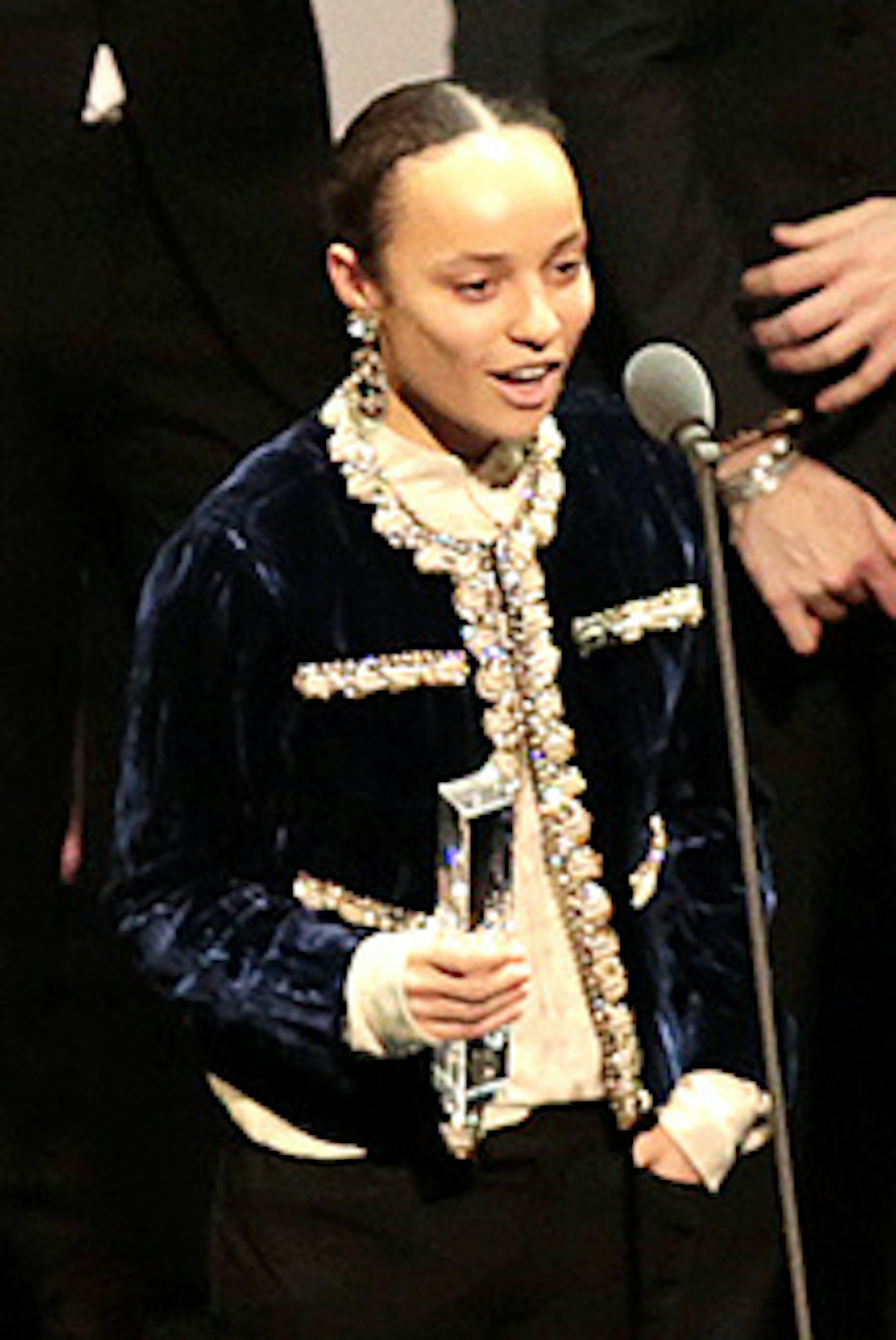 A young mixed race woman receiving a royal honour.