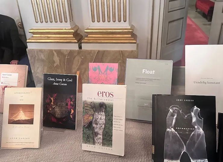 A table featuring an array of books propped up on book stands.