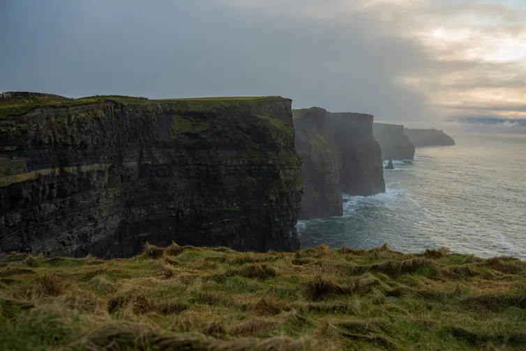 Big cliffs tower above the sea