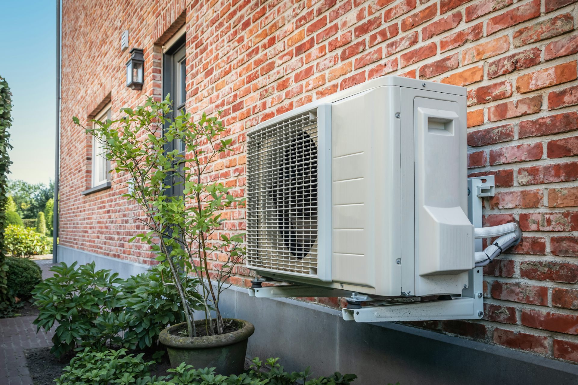 A heat pump on the side of a house