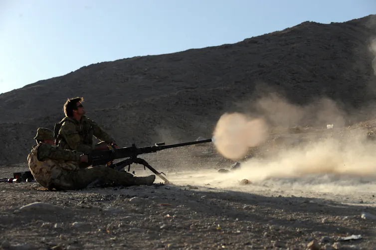 Australian soldiers fire a machine gun in the province of Uruzgan, Afghanistan.