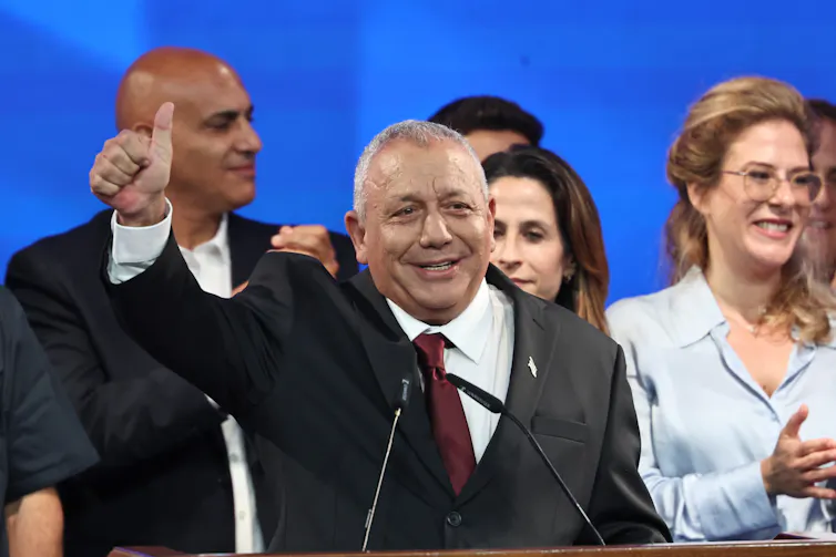 Israeli opposition leader Gadi Eisenkot holds a thumbs up to supporters.