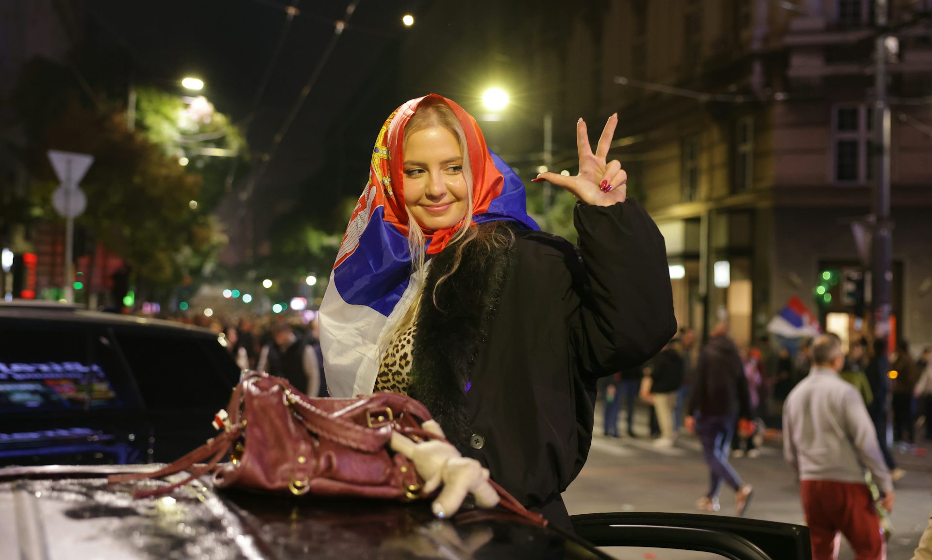 A crowd waves Serbian national flags in Belgrade.