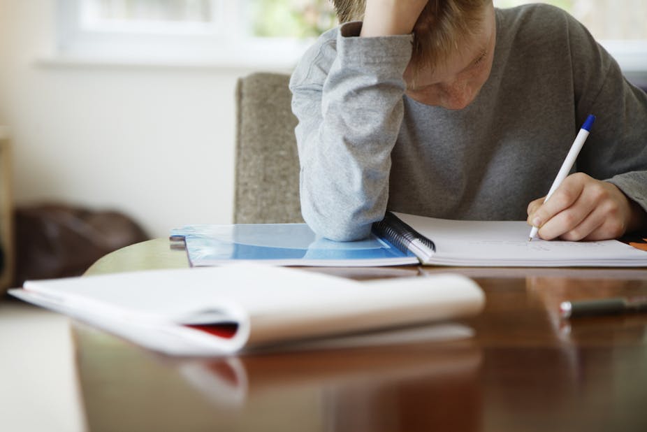 teen writes in notebook